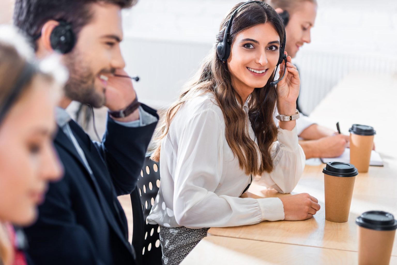 selective focus of call center operators working at workplace in office